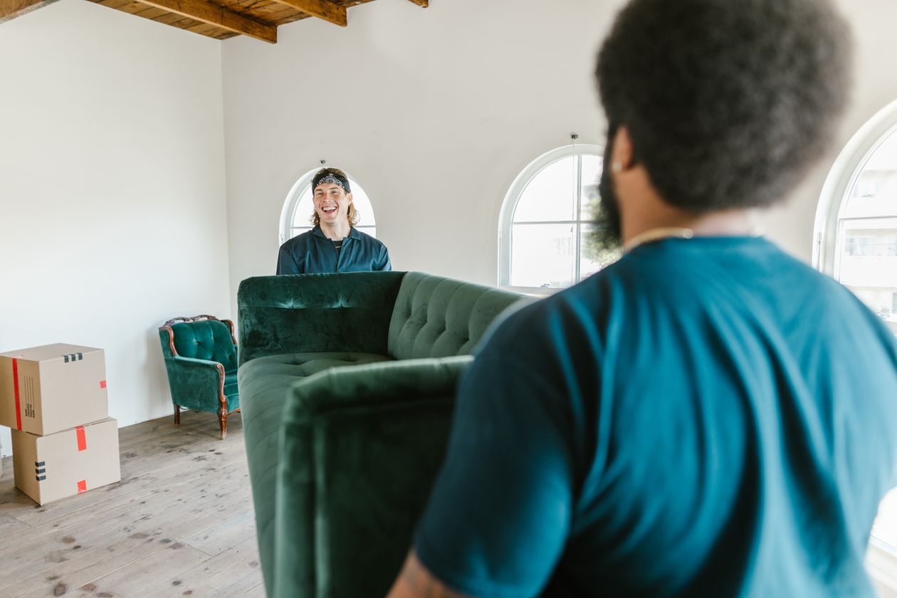 Movers carrying a sofa for furniture removal in Sudbury